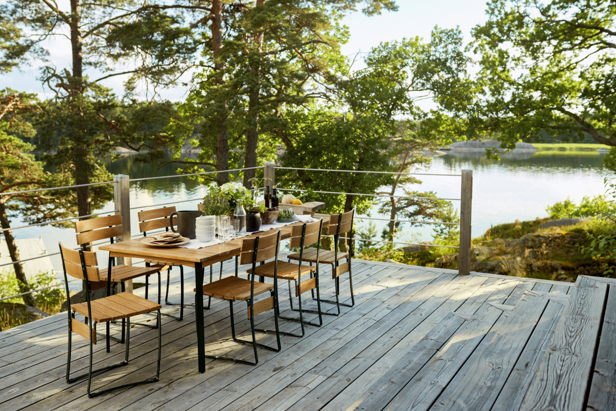 Kerteminde large outdoor dining table by Skargaarden in teak with green powder-coated steel frame