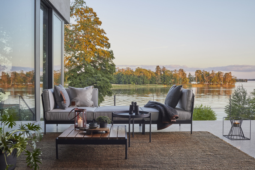 Lido modular outdoor sofa by Skargaarden on a modern terrace overlooking a lake.
