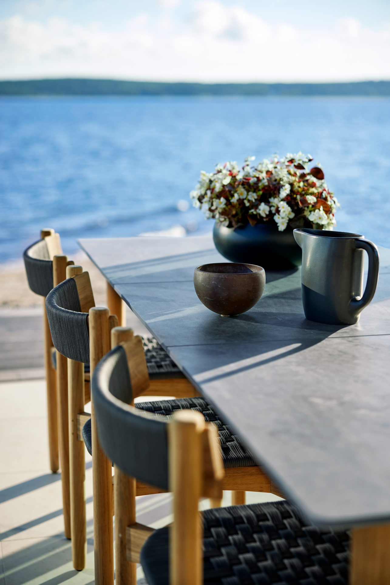 Koster Dining Table 230 by Skargaarden with light grey ceramic tabletop and solid teak frame.