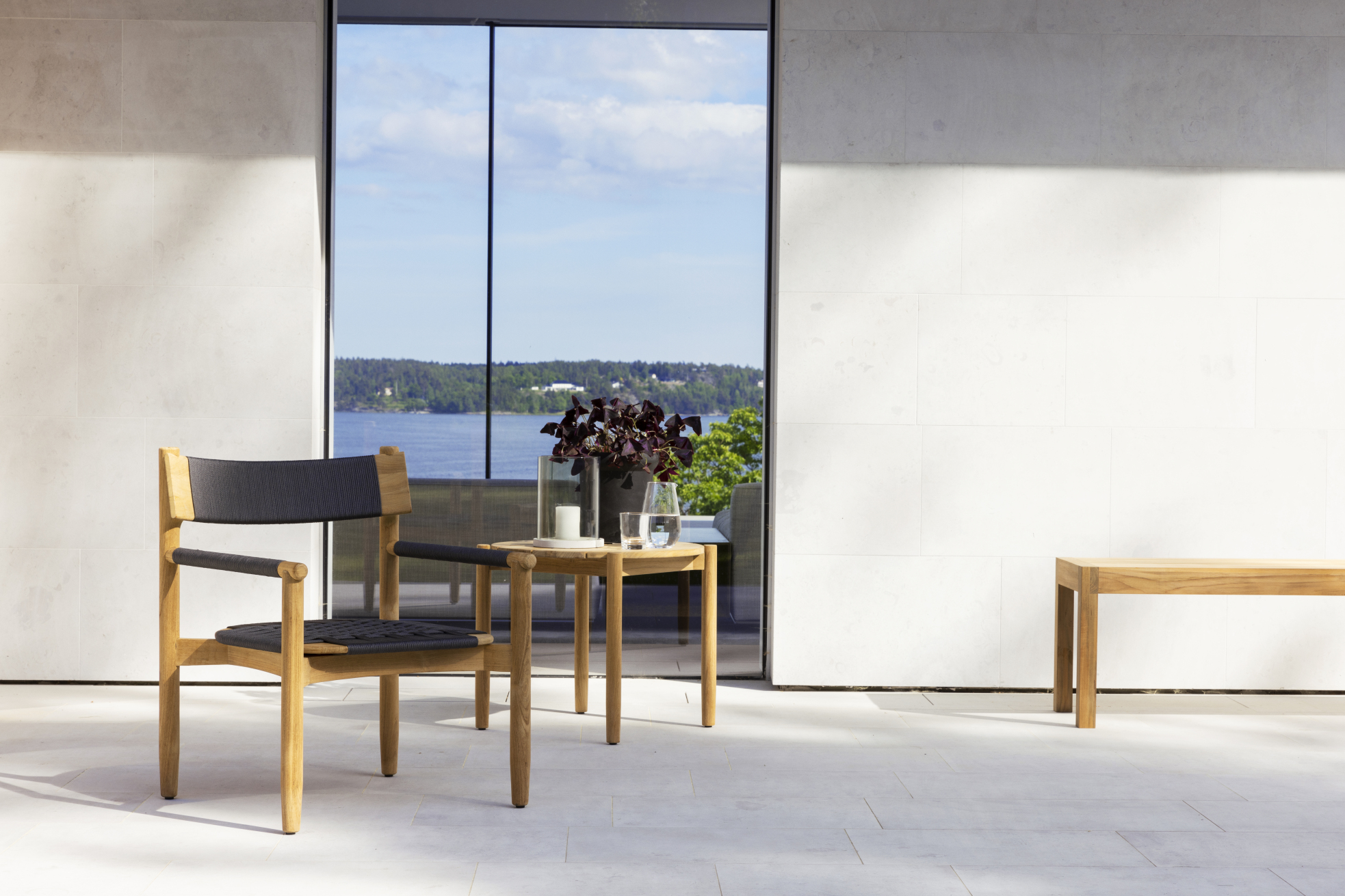 Koster Lounge Chair by Skargaarden in solid teak with dark grey woven outdoor rope seat and backrest.